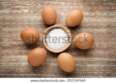 Fresh eggs on wood background. Top view.