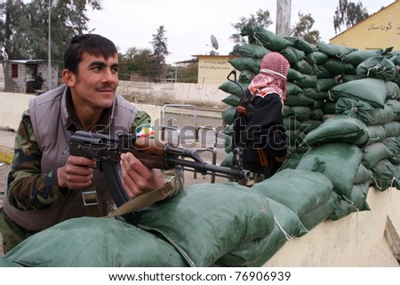 KIRKUK, IRAQ-JANUARY 21: An unidentified Kurdish soldier stands guard on a check point in front of Kurdistan Democratic Party Building on January 21, 2007 in Kirkuk, Iraq.