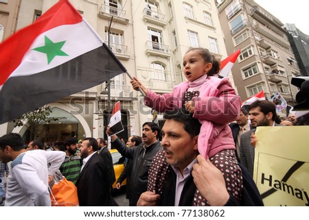 ISTANBUL,TURKEY-MAY 13: Unidentified Syrians living in Istanbul and Civil Society Organizations protest the regime of Bashar Essad in front of Syrian Consulate building on May 13, 2011 in Istanbul, Turkey.