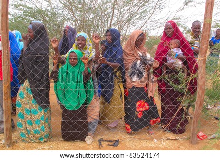 DADAAB, SOMALIA-AUGUST 15: Unidentified women and children wait for relief aid in the Dadaab refugee camp where thousands of Somalis end up due to hunger on August 15, 2011 in Dadaab, Somalia.