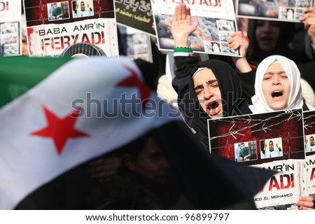 ISTANBUL,TURKEY-MARCH 2:A group of unidentified people stage a demonstration in front of the Beyazit Mosque, protesting Syrian authorities\' violent crackdown in Homs on March 2,2012 in Istanbul,Turkey