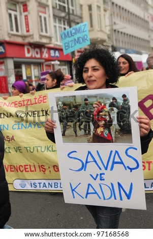 ISTANBUL,TURKEY-MARCH 8: Unidentified woman in purple costume celebrates international women\'s day on March 8,2012,in Istanbul,Turkey