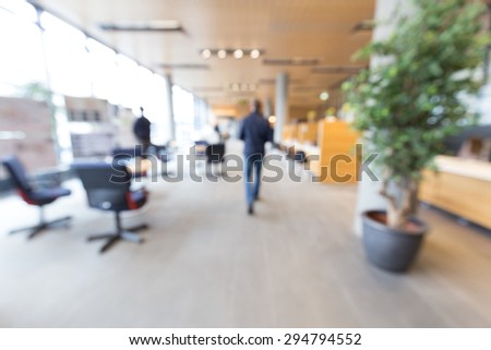 Out of focus shot of a man walking into a generic service center