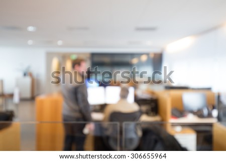 Out of focus shot of two coworkers working together in an office setting