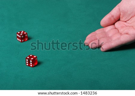 Dices being thrown in a craps game, or any kind of dice involved game, Dices are a clear red color on a green felt table