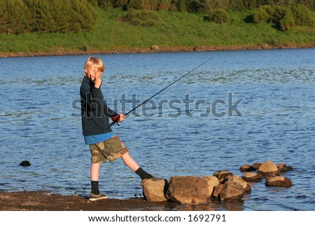 a boy fishing in a trout lake in northern europe