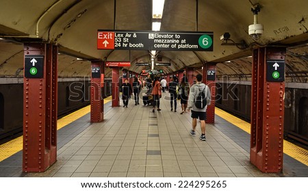 NEW YORK - SEPTEMBER 21, 2014: MTA subway train station platform with people traveling in New York. The NYC Subway is a rapid transit/transportation system in the City of NY.