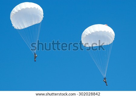 Zhitomir, Ukraine - 28 February 2006. Couple paratroopers parachute jumps in the winter.