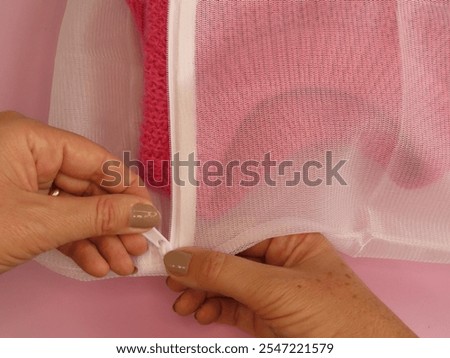 Similar – Image, Stock Photo Women hand in pullover holding Christmas gift with red ribbon. Blue knitted blanket with cup of cappuccino. Snowflakes and winter decoration. Top view. Flat lay