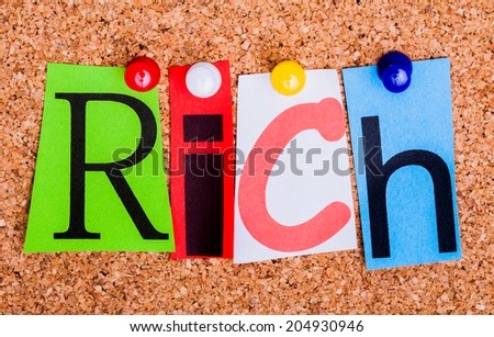 The word Rich in cut out magazine letters pinned to a cork notice board.