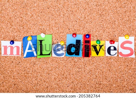The word Maledives in cut out magazine letters pinned to a cork notice board