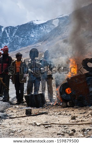 KHARDUNG LA PASS, INDIA - SEPTEMBER 12: Indian people working at road construction at Khardung La pass. The one main road at Himalaya mountains, altitude 5600 m. India, Ladakh, September 12, 2012