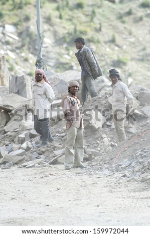 KEYLONG, INDIA - SEPTEMBER 06: Unidentified Indian people from poorest state Bihar,  working at road construction near Keylong village, Manali-Leh  highway. India, Himachal Pradesh, September 06, 2012