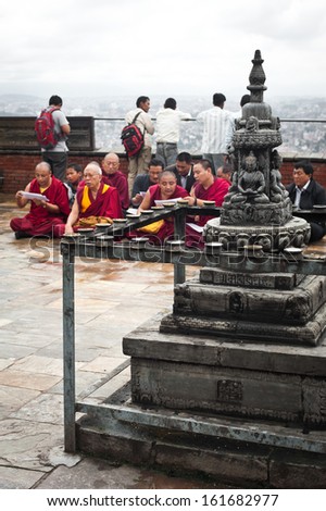 KATHMANDU, NEPAL - SEPTEMBER 18: Buddhist monks providing religious ceremony and blessing people at Buddhist Shrine Swayambhunath Stupa named Monkey Temple on September 18, 2012. Nepal, Kathmandu