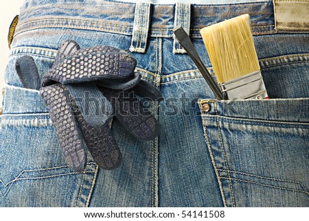Industrial tools and instruments. Working tools in the back pocket of old used jeans
