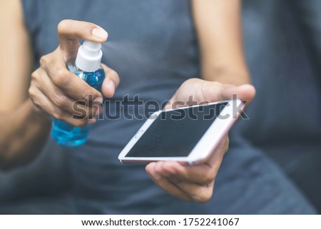 Similar – Image, Stock Photo Woman disinfecting phone with antiseptic wet wipe. Antiseptic napkin to prevent spread of germs, bacteria and coronavirus. Coronavirus prevention. Prevent illness coronavirus after public place.