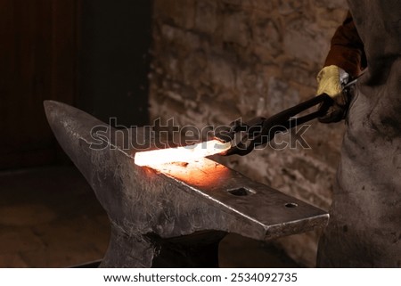 Similar – Image, Stock Photo Blacksmith hands forging molten metal on anvil