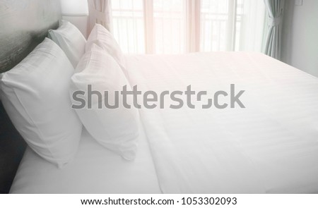 Similar – Foto Bild Das Bett ist mit sauberen weißen Kissen und Bettwäsche im Zimmer ausgestattet.