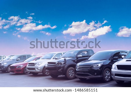 Car parking in asphalt parking lot with white cloud and blue sky background. Outdoor parking lot with fresh ozone and green environment of transportation concept