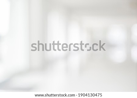 Empty blur white corridor hallway of modern white office building room with entrance door business blur background