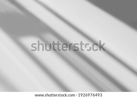 Abstract shadow and striped diagonal light blur background on white wall  from window,  architecture dark gray and sunshine diagonal geometric effect overlay for backdrop and mockup design