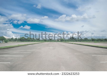 Similar – Image, Stock Photo Empty parking lot. A sign ‘Lehrerparkplatz’ in front of a school building with closed shutters