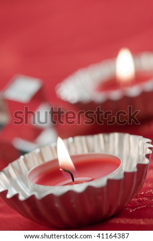a close up of little candles tea-light on red