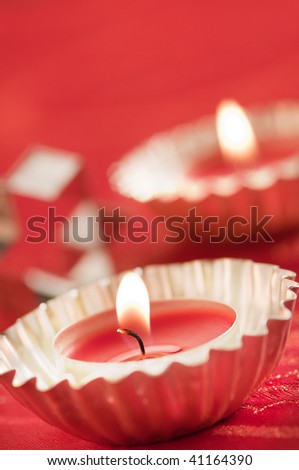 a close up of little candles tea-light on red