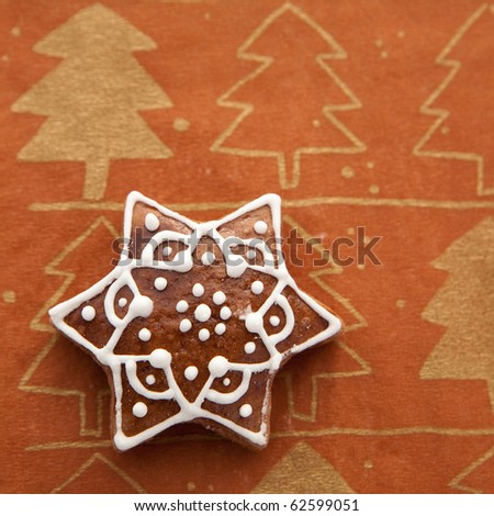 gingerbread as star on background with christmas decoration