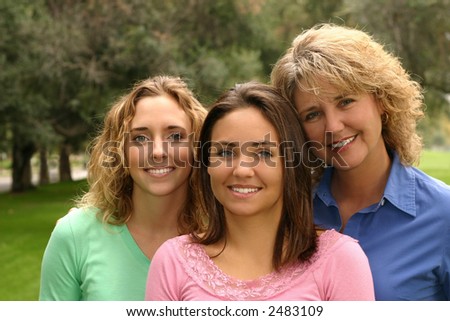 pretty mother with her two beautiful daughters.