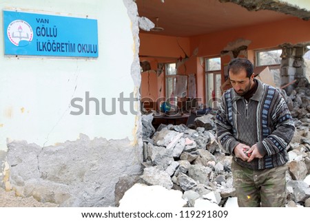VAN, TURKEY-NOVEMBER 1: Earthquake damage in the Gollu Village in Van, Turkey.  View of ruined Gollu Primary School with local unidentified man on November 1, 2011.