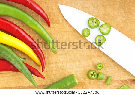 The ceramic knife and sliced chili peppers