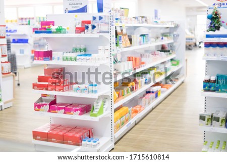 At the chemist, Medicines arranged in shelves, Pharmacy drugstore retail Interior blur abstract backbround with medicine and healthcare product on cabinet with ืneon light with vaccine.