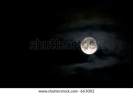 Full moon surrounded by clouds