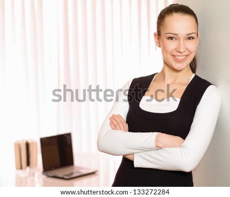 Portrait of a young business woman standing in office