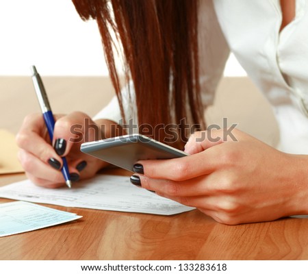 A woman with documents  at the desk - on white background