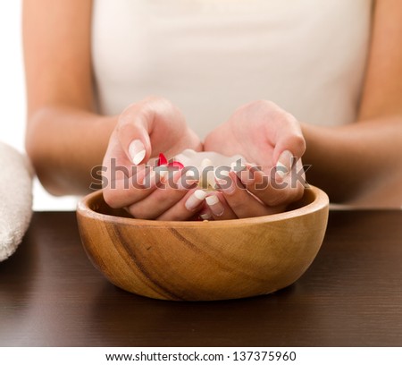 Woman\'s hands in bowl of water