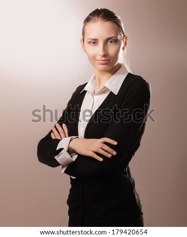 Portrait of beautiful business woman standing with folded arms