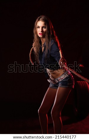 Portrait of young woman standing in the old garage. isolated on black background