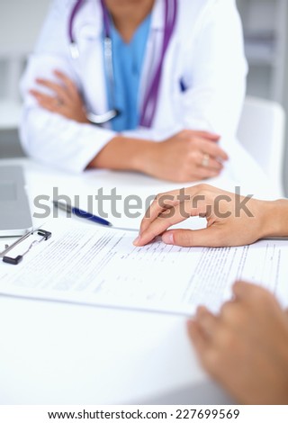 Doctor and patient sitting on the desk  at office, isolated