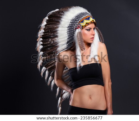 Beautiful woman in native american costume with feathers, isolated