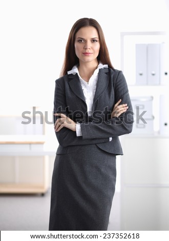 Portrait of businesswoman standing with crossed arms in office