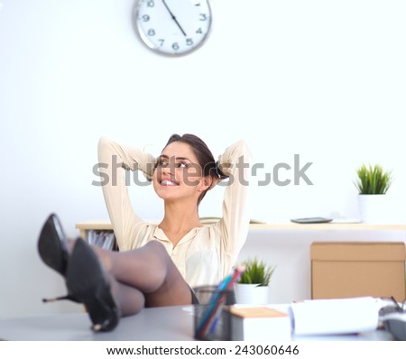 Business woman  relaxing with her hands behind her head and sitting on a chair