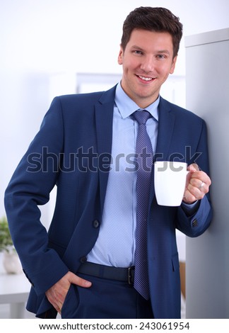Close up of a handsome businessman drinking tea
