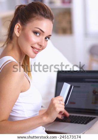 Woman shopping online with credit card and computer.Internet Shopping