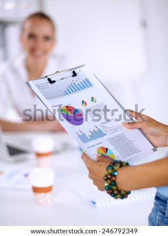 Close-up of businesswoman holding folder in hands