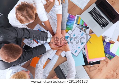 Business team with hands together - teamwork concepts.