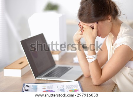 Portrait of tired young business woman with laptop computer