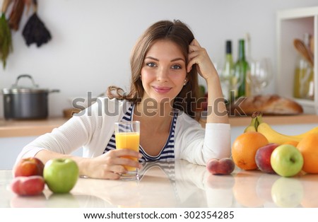 Portrait of a pretty woman holding glass with tasty juice .