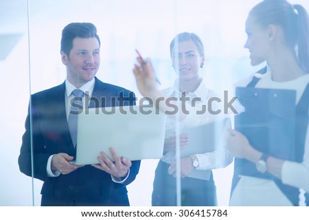 Group of  business people doing presentation with laptop during meeting .